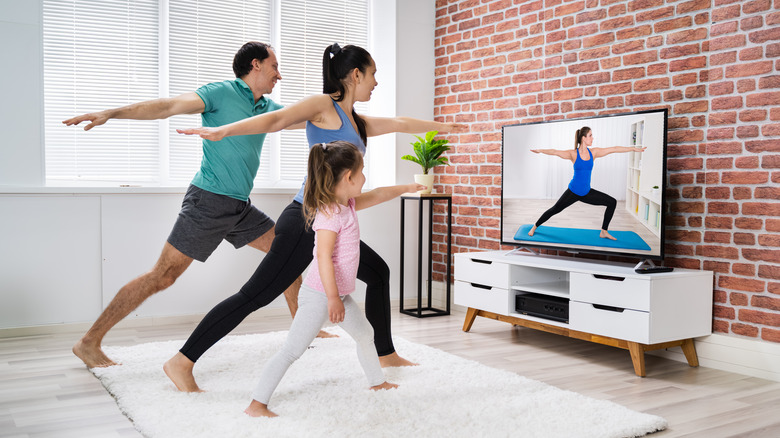 Family doing exercise at home on TV