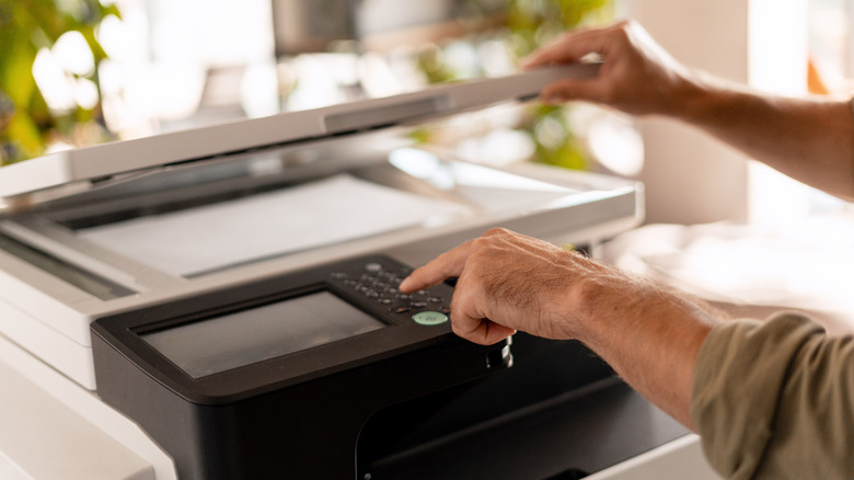 A person operating a printer