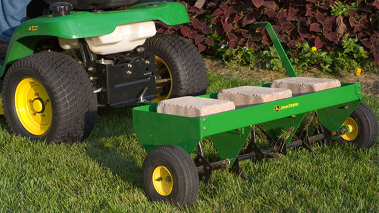 A John Deere tractor pulling a tiller