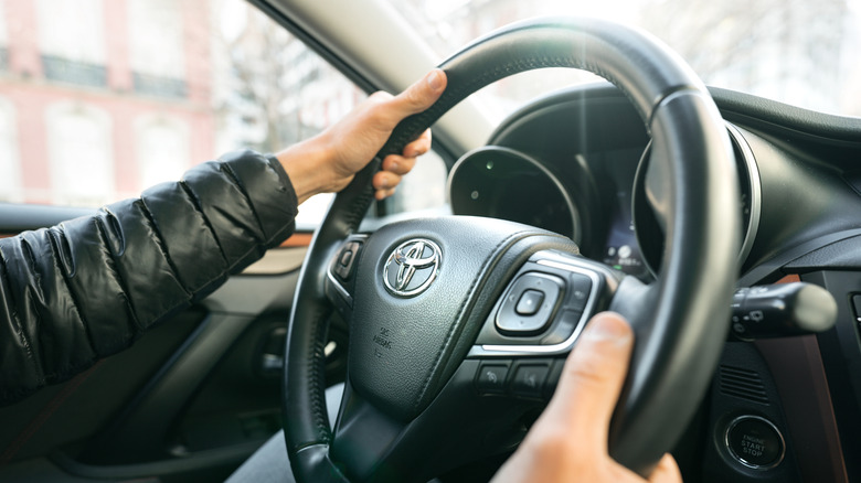 closeup of man driving a Toyota