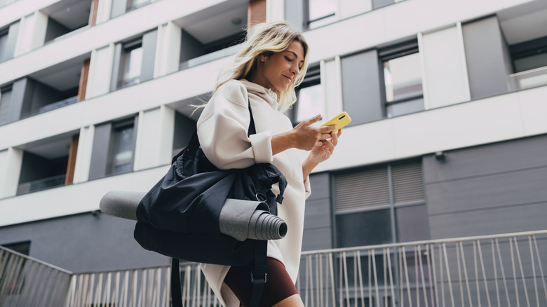 woman with phone workout gear