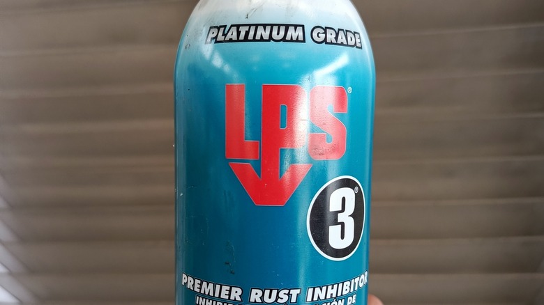 Person holding can of rust inhibitor