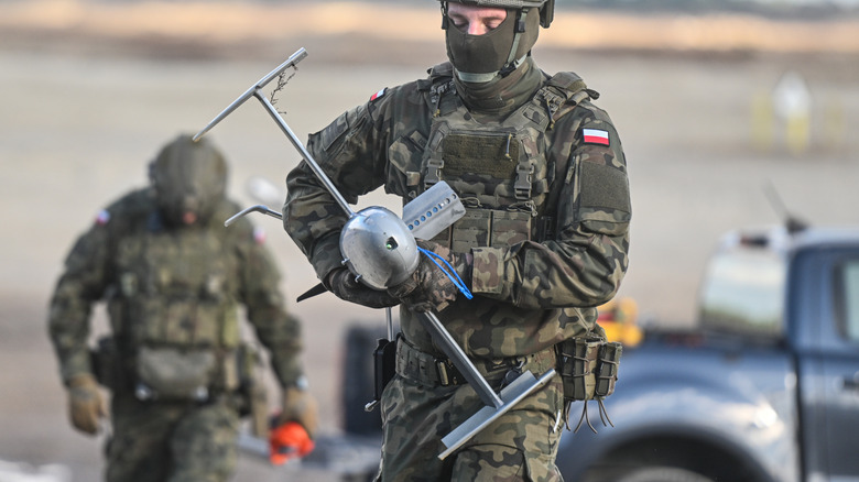 A Polish soldier holding a merops drone.