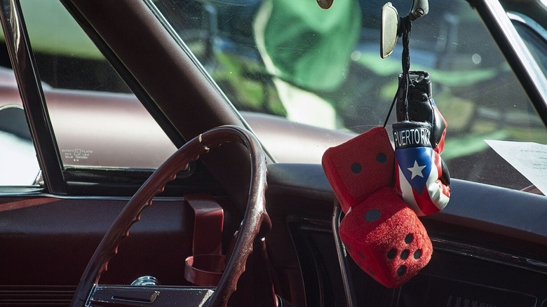 fuzzy dice with a Puerto Rican boxing gloves in a classic car