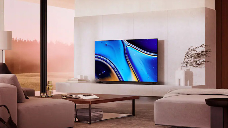 A Sony Bravia Android TV hanging on a wall in a living room