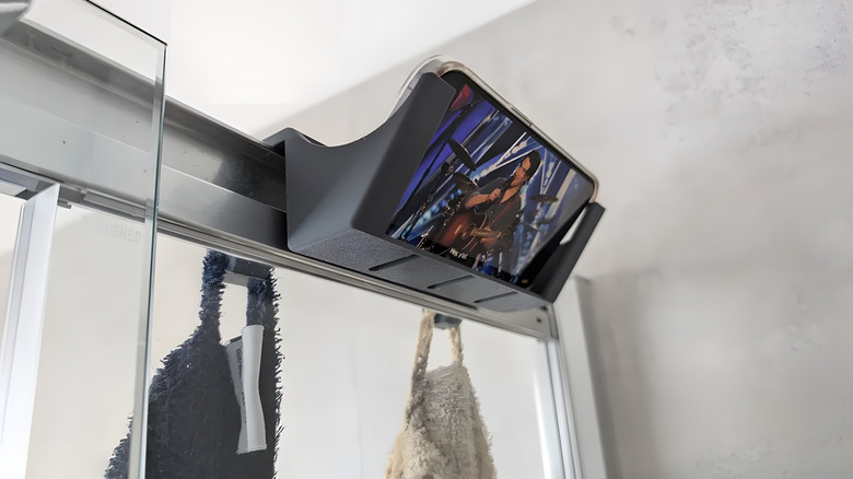 Shower phone holder playing a video with the phone