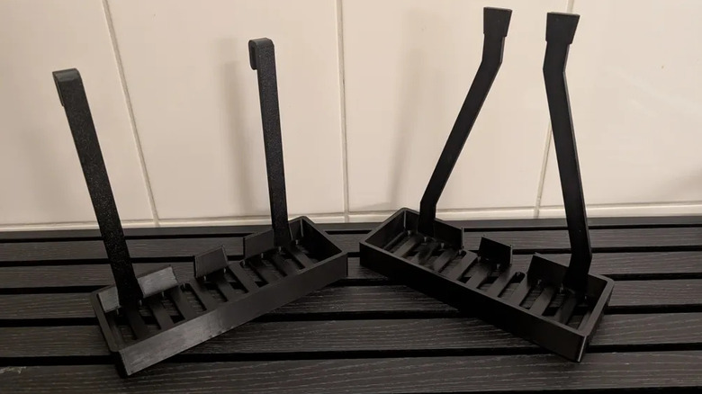 Two shower trays on a flat surface