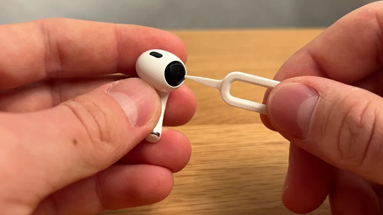 Someone cleaning earbuds with the Earbuds Cleaning Tool