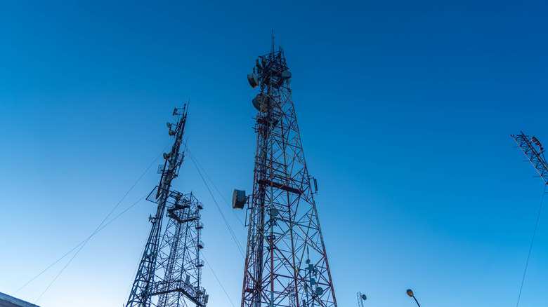 Two mobile towers next to each other against a blue sky