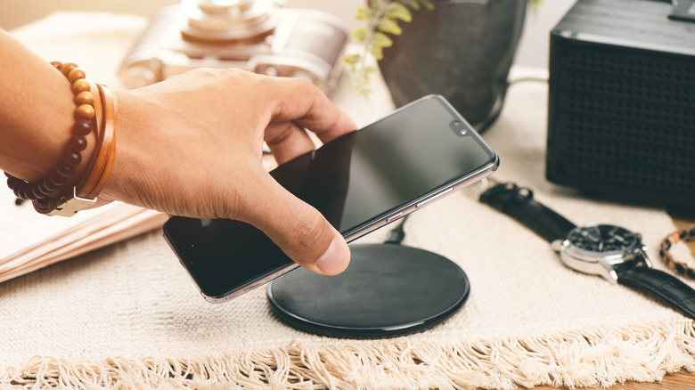 Smartphone being placed on wireless charging pad