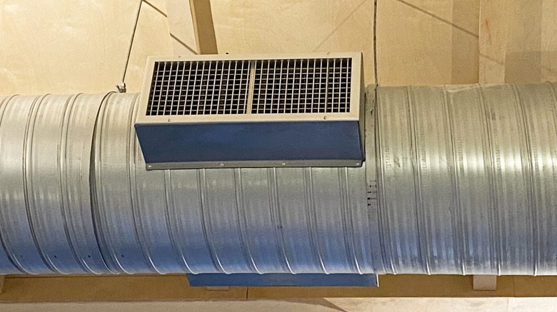 An industrial air filtration system on the ceiling