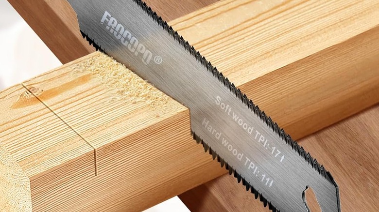 Cutting a piece of wood with a Frocopo Hand Saw.
