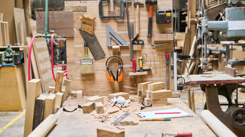 A woodworking bench covered in various tools.