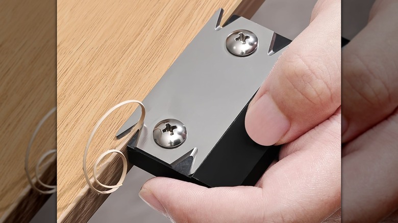 A person cutting the side of a board with a Necamocu Edge Banding Trimmer.
