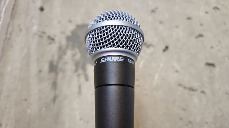 Shure SM58 microphone photographed against concrete backdrop