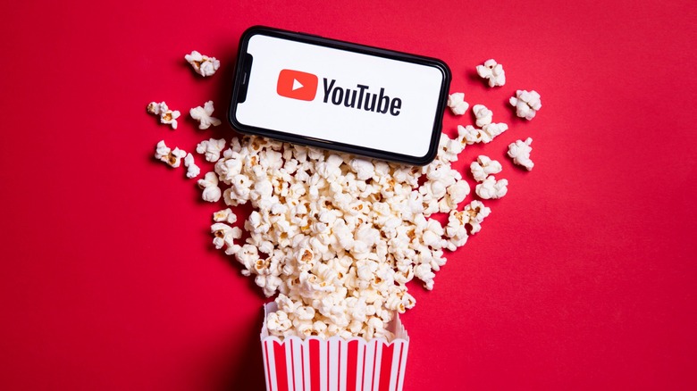 popcorn spilling out, phone with YouTube on it
