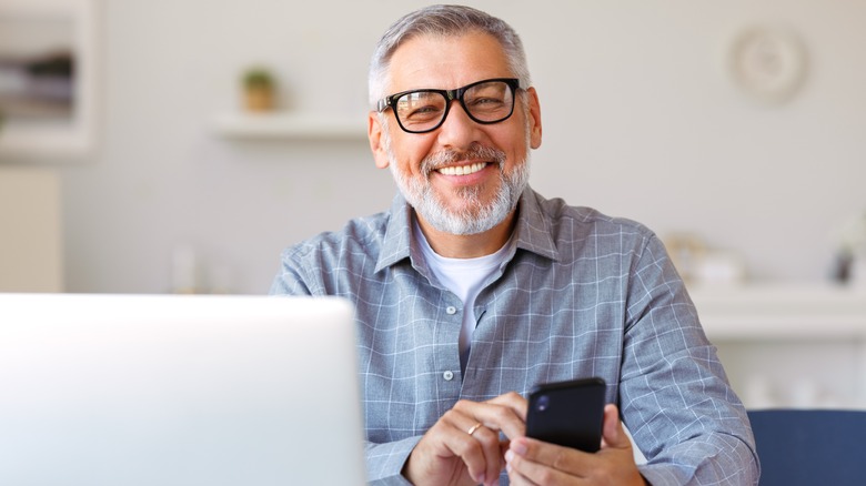 person with cell phone smiling