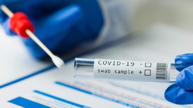 COVID test swab and vial