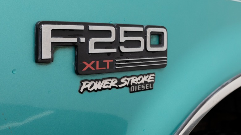 A Power Stroke badge on a 1990's Ford F-250 fender.