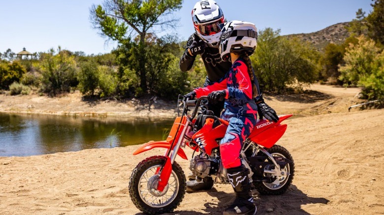 Person teaching kid to ride
