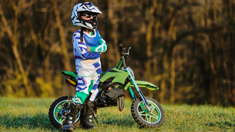 Young rider next to dirt bike