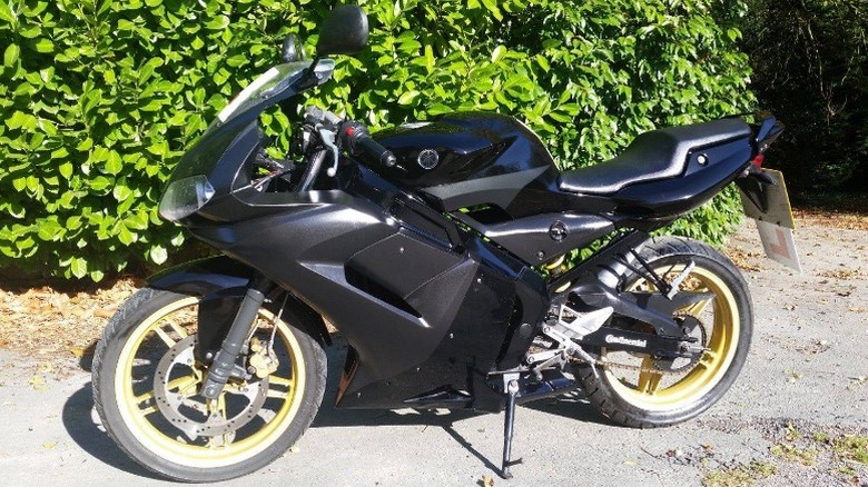 Yamaha TZR 50 parked on dirt path