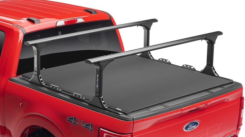 Truck racks mounted on a Ford 4x4 pickup truck that also has a tonneau cover installed