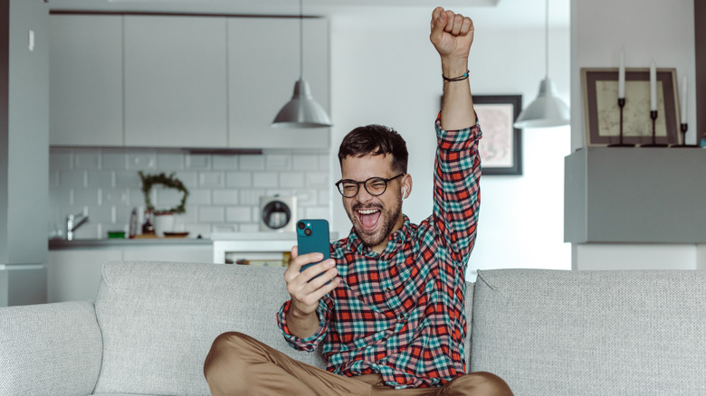 Man cheering with phone