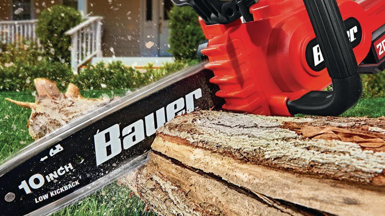 person using bauer chainsaw