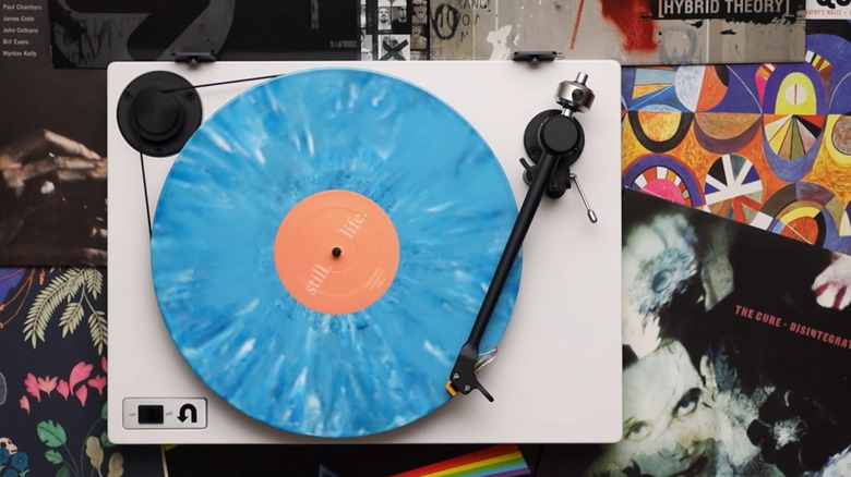 White U-Turn Orbit Basic turntable playing a blue vinyl record.