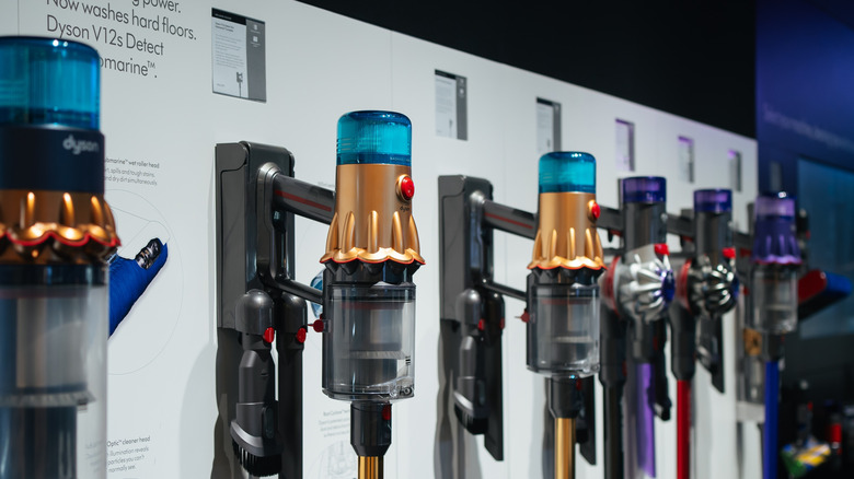 Dyson vacuums hanging from a wall