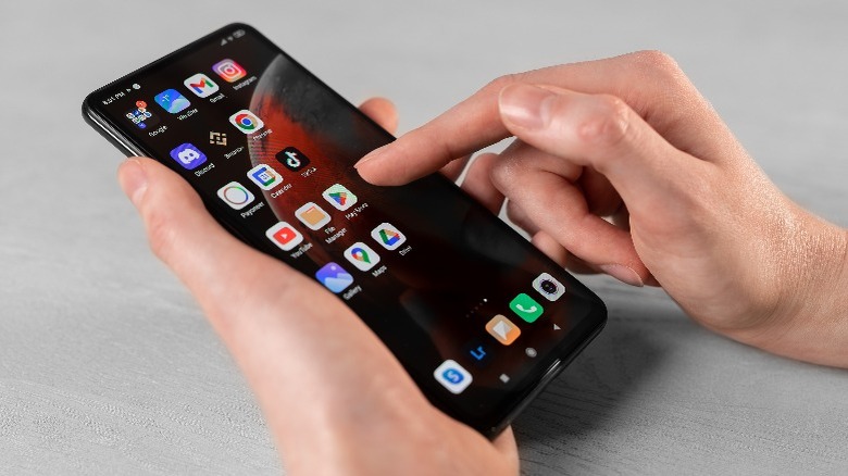 Person tapping on an Android phone