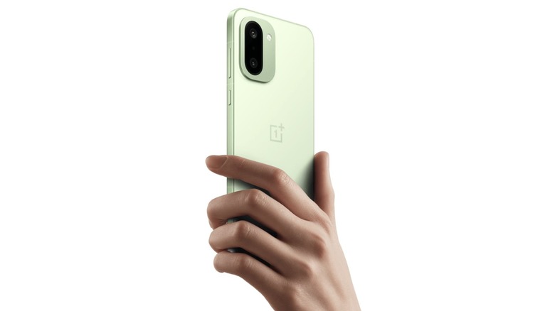 Hand holding up a OnePlus 15R phone
