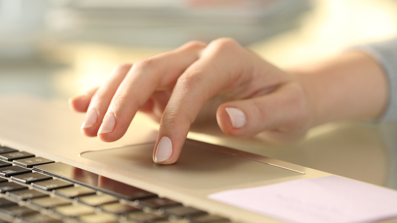 Hand on laptop trackpad