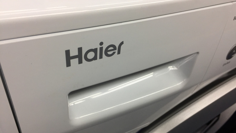 close-up of Haier logo on a washing machine