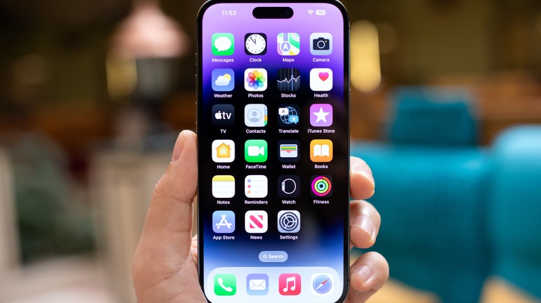 hand holding iPhone in home screen