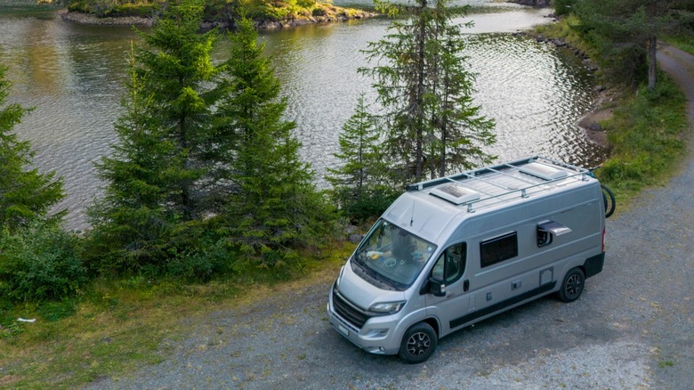 Van parked next to a river