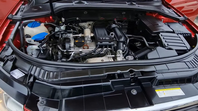 An orange 2012 Audi A3 Sportback in the 5-door configuration with its hood open, showing the 1.2-liter TFSI engine.