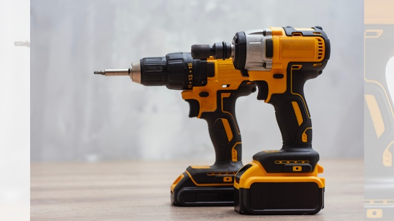 an impact driver and a power drill on a work bench