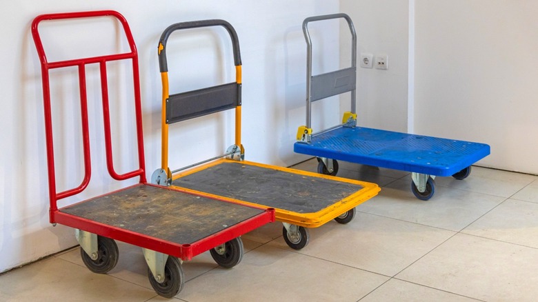 a set of platform hand trucks lined up near a corner