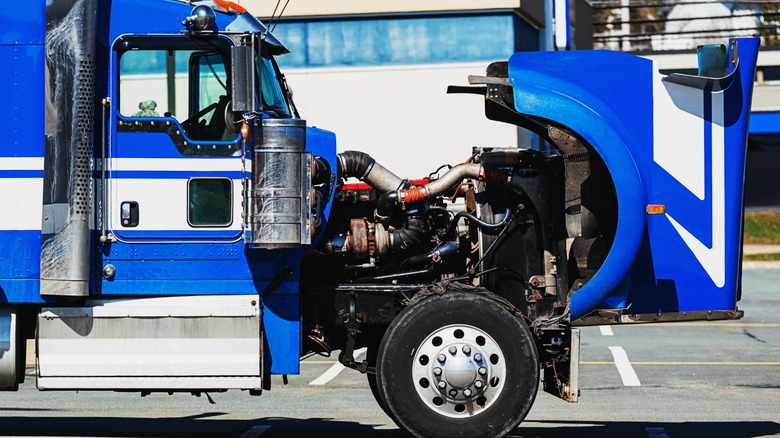 Blue semi-truck with the engine bay open