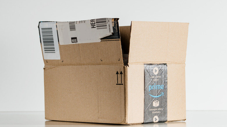 An open Amazon box against a gray background