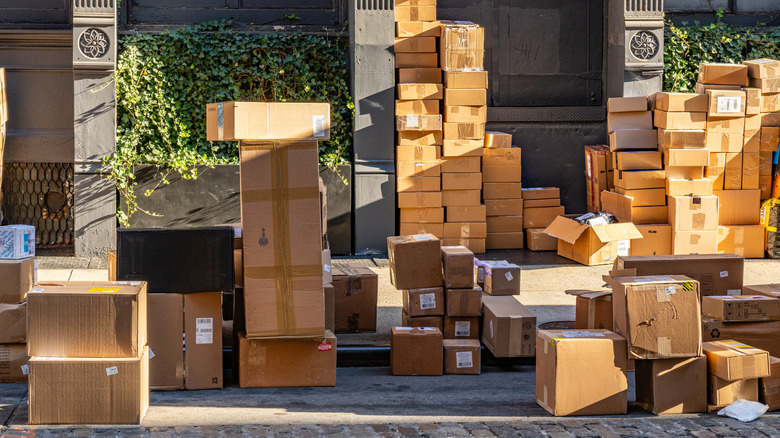 Stacks of packaged cardboard boxes on the side of a street