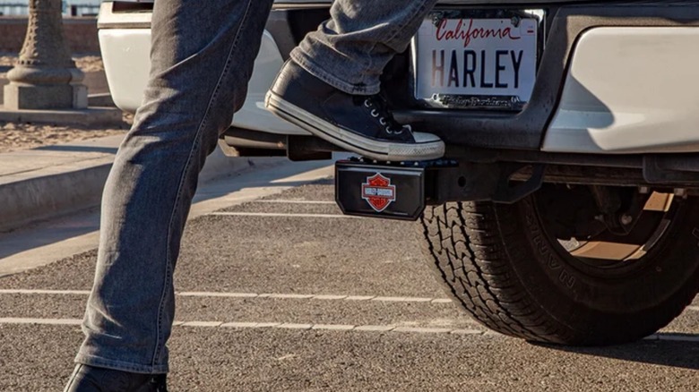 A person using a Harley-Davidson step hitch cover