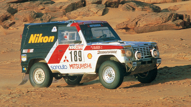 Side view of 1980s Mitsubishi Pajero competing in the 1985 Dakar Rally.