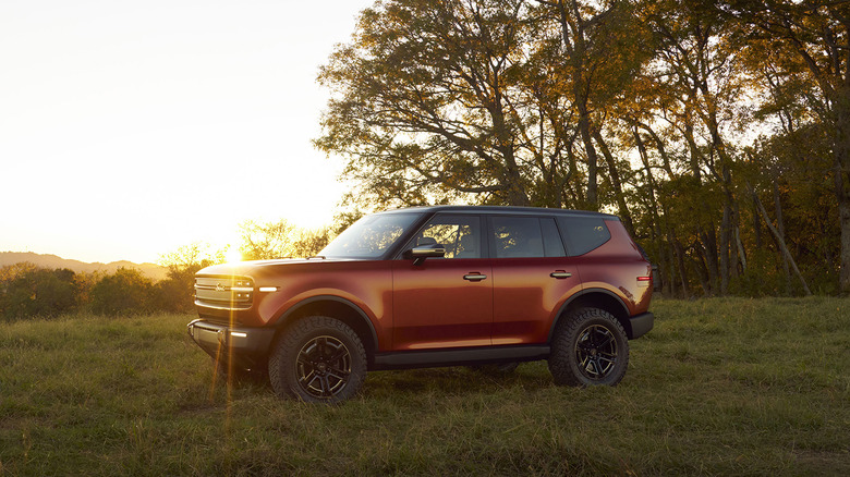 An orange Scout Motors Traveler parked