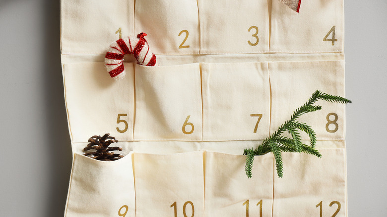 A DIY Advent calendar hanging off a wall.