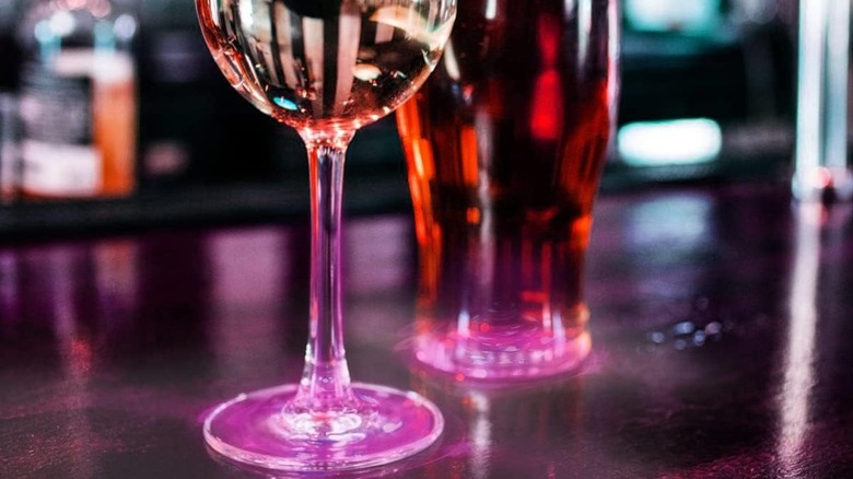Two glasses with LED coasters attached to the bottom.