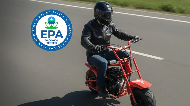 person in black helmet and leather jacket riding FRP GMB100 mini-bike on rural road