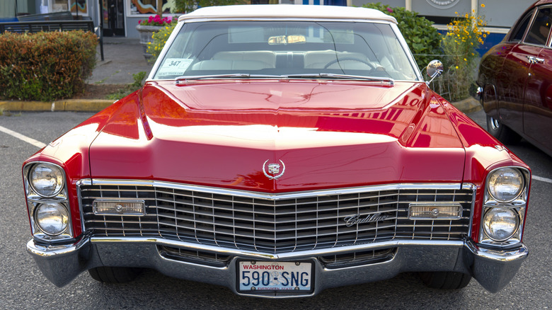 A red vintage Cadillac Deville in parking lot